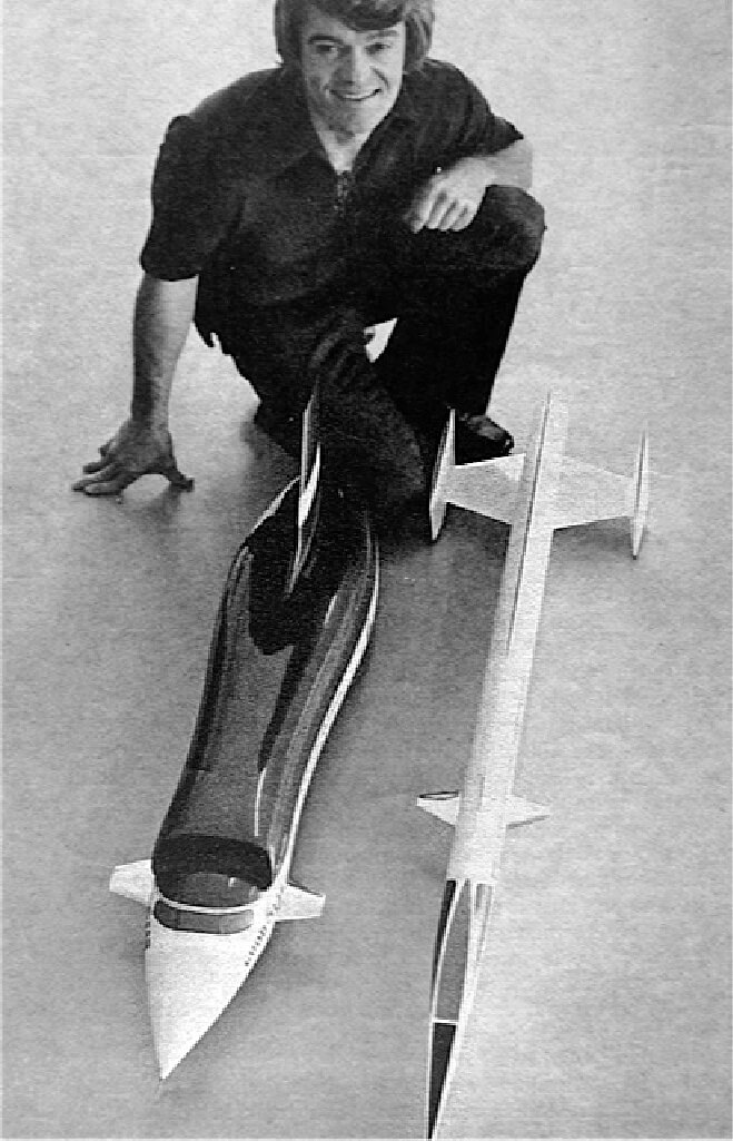 Craig Breedlove with a models of Sonic I and a concept for a rocket car