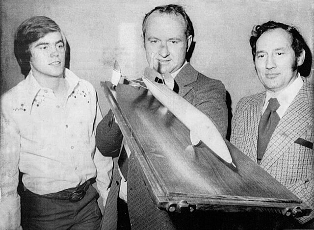 Bill Fredrick holds a model of a 1970 concept of a rocket car. Art Arfons is on his right.