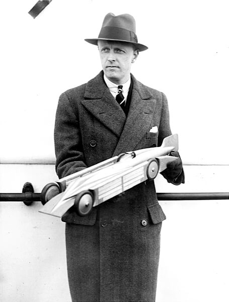 Sir Henry Segrave with a model of his 1929 Land Speed Record holder, the Golden Arrow
